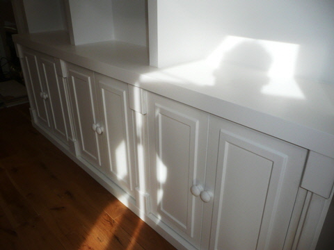 Elegant fitted alcove cabinetry with integrated shelving
